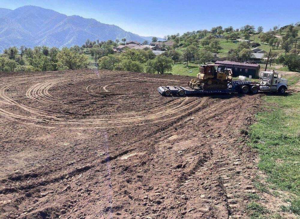 Lowbed truck hauling a bulldozer to a job site